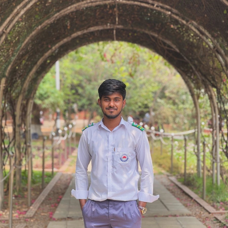 Nayem in college uniform under a garden arch